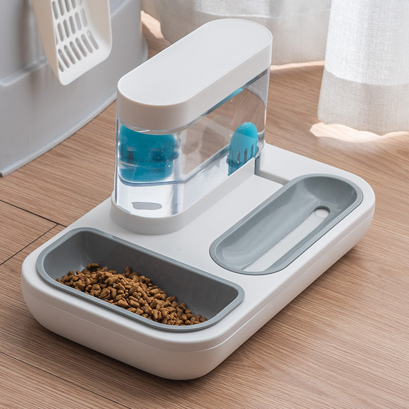 Pet Supplies Automatic Pet Cat Feeder An automatic pet cat feeder with a white base and blue water compartment, featuring two bowls for food and water, placed on a wooden floor.