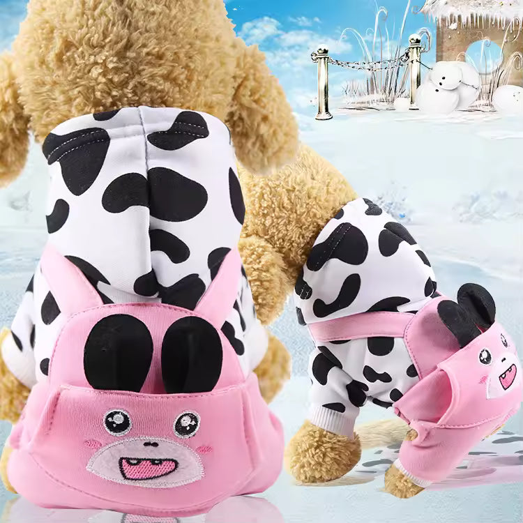 Pet Supplies Warm Fleece Hooded Pet Hoodie Cow print outfit with pink bear face design on a teddy bear in a snowy scene.
