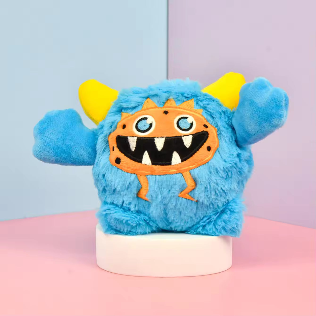 Pet Supplies Interactive Squeaky Plush Dog Toy Blue plush toy with a smiling face on a pink and blue background