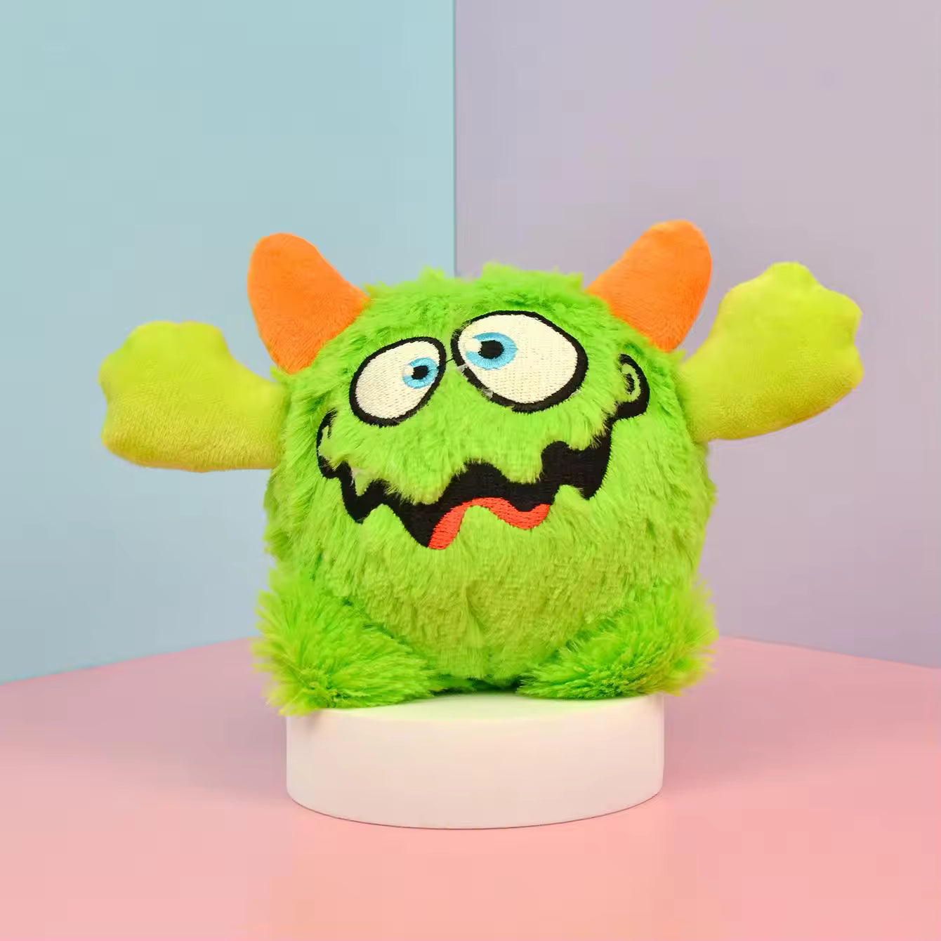 Pet Supplies Interactive Squeaky Plush Dog Toy Green plush toy with orange ears on a pink and blue gradient background