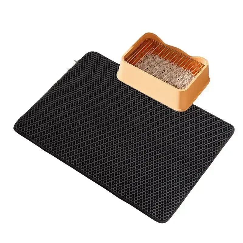 Pet Supplies Non-slip  Cat Litter Mat A beige non-slip cat litter mat with a Black litter box and a scoop on top of the mat with white background